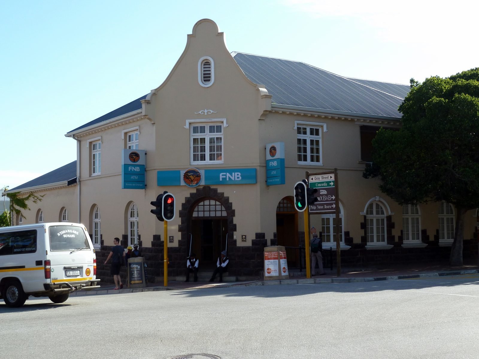 FNB branch with blue FNB and ATM signs on a Cape Dutch style building