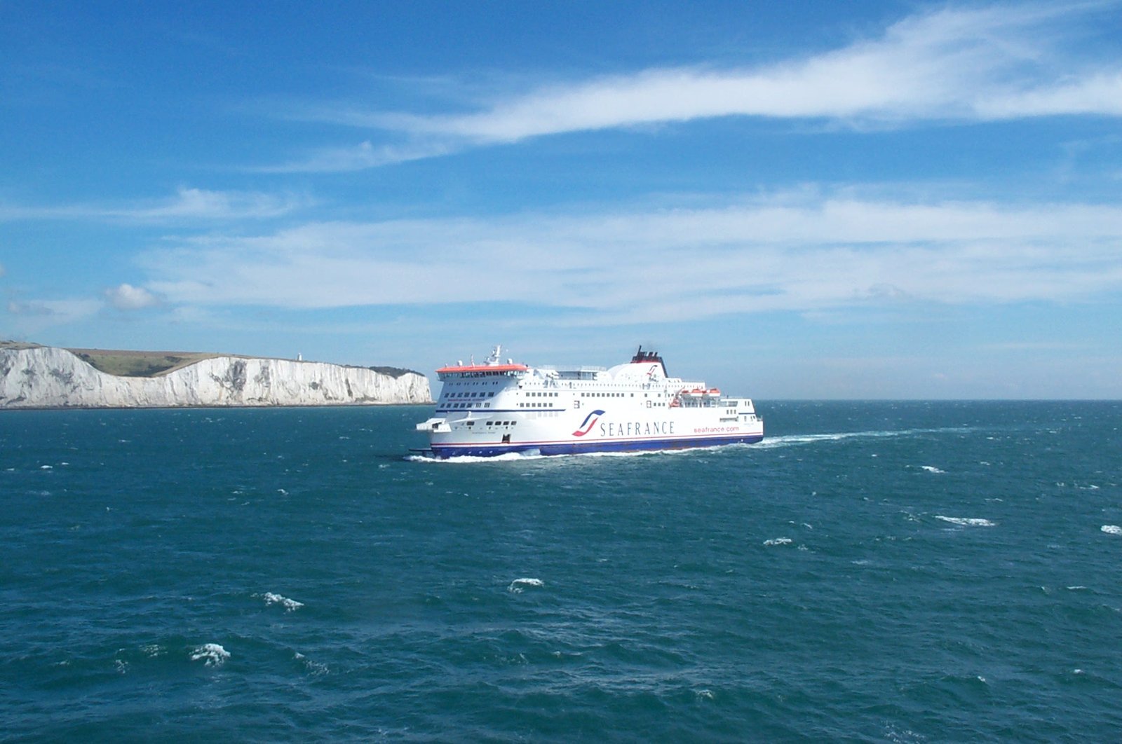 A ferry crossing the English Channel with the white cliffs of Dover in the background