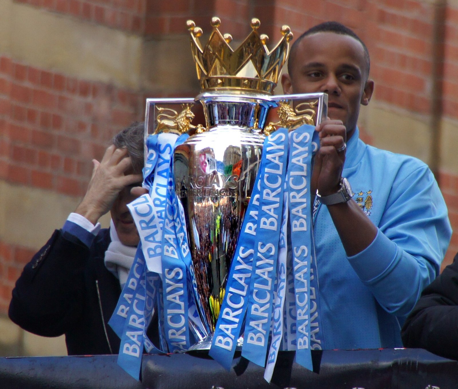 Vincent Kompany lifts the Premier League trophy in 2012 with Roberto Mancini behind him