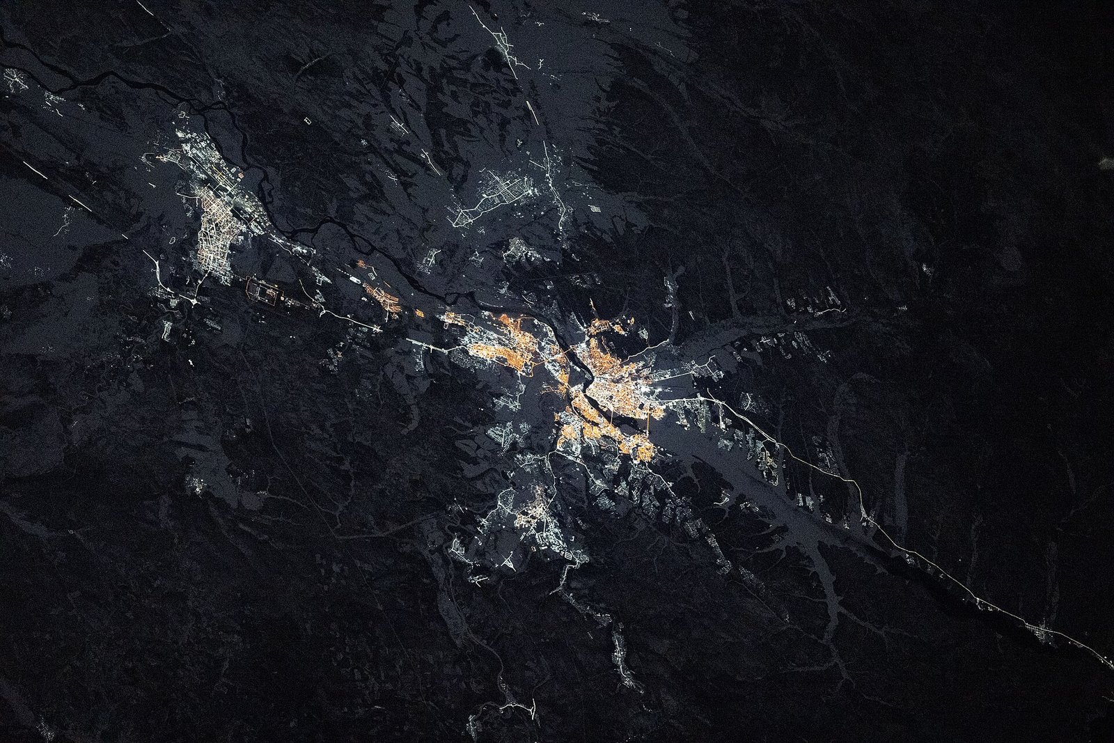 Night view from the International Space Station of the lit-up city of Irkutsk split by the Angara River