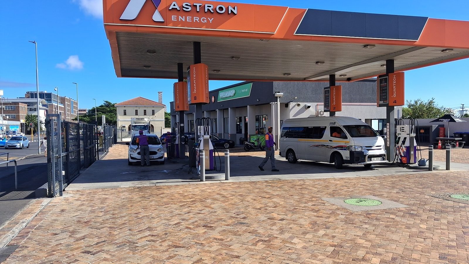 An Astron Energy petrol station in Cape Town with a minibus taxi at the pumps